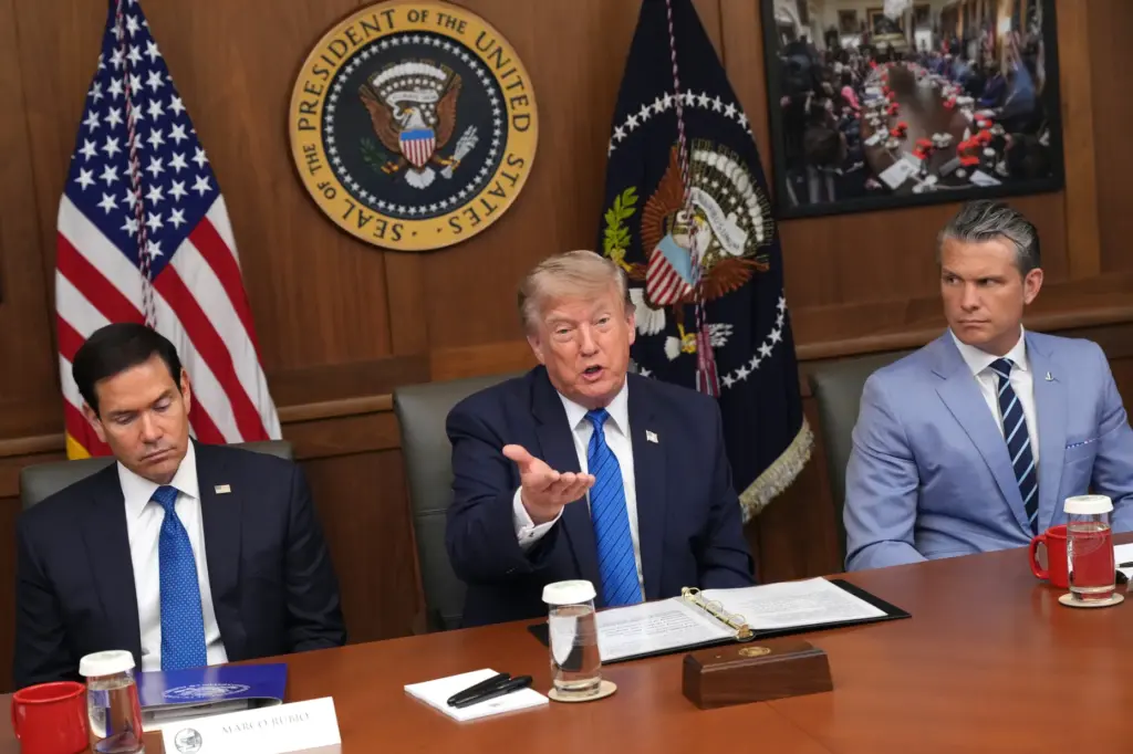 President Donald Trump speaks as Secretary of State Marco Rubio and Defense Secretary Pete Hegseth listen.