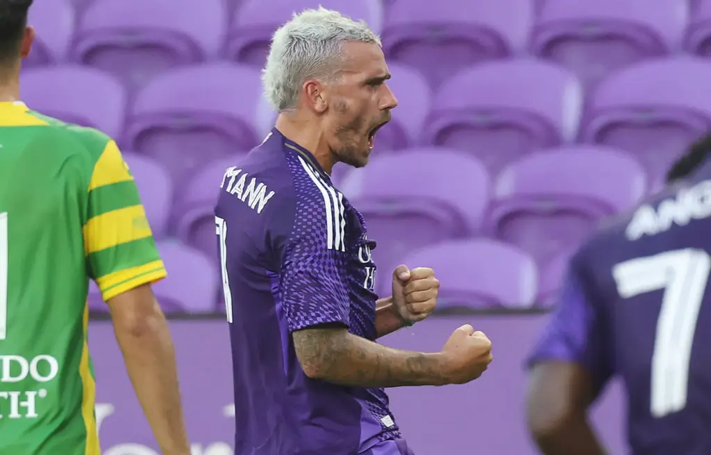 Orlando City player Antoine Griezmann screams in celebration after scoring...