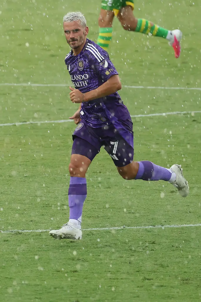 Orlando City player Antoine Griezmann runs in the rain during...