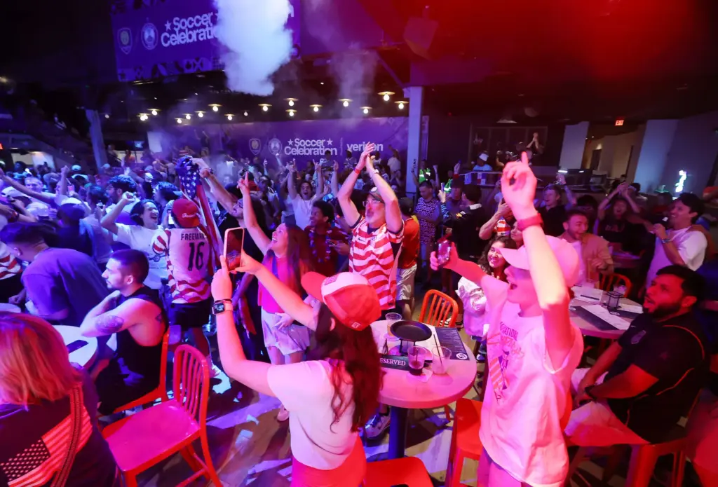 USA soccer fans cheer after a USA goal during a...