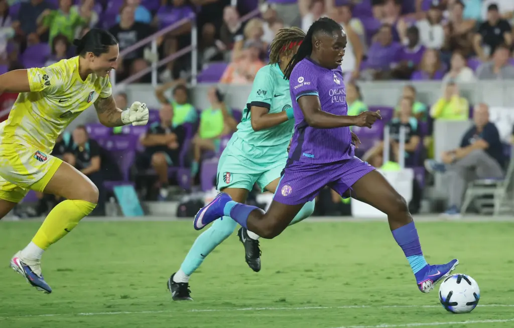 Orlando player Barbra Banda (right) scores a goal past KC...