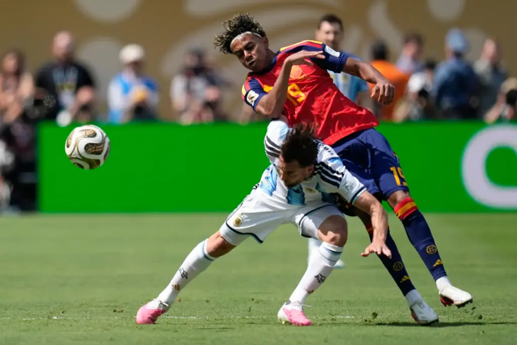 Argentina’s Nicolas Tagliafico vies for the ball with Spain’s Lamine...
