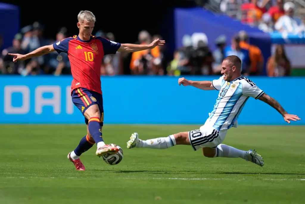 Argentina’s Alexis Mac Allister, right, tries to tackle Spain’s Dani...