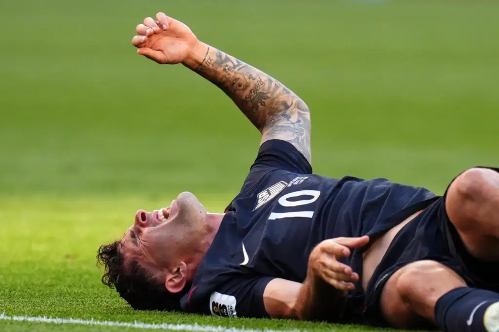 United States’ Christian Pulisic (10) reacts after a challenge during...