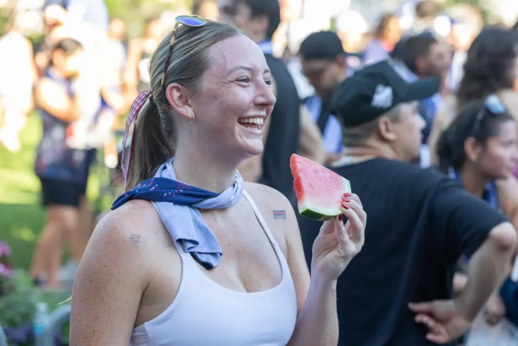 A runner smiles with her watermelon after finishing the Watermelon...