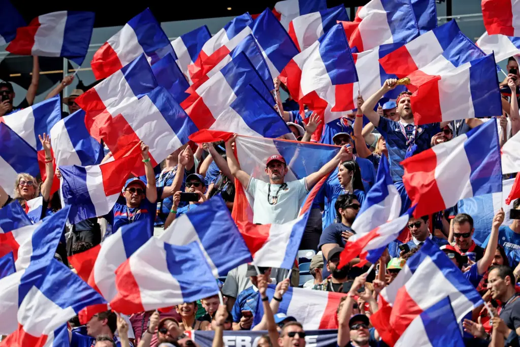 Foxboro, MA – July 9 – French fans wave their...