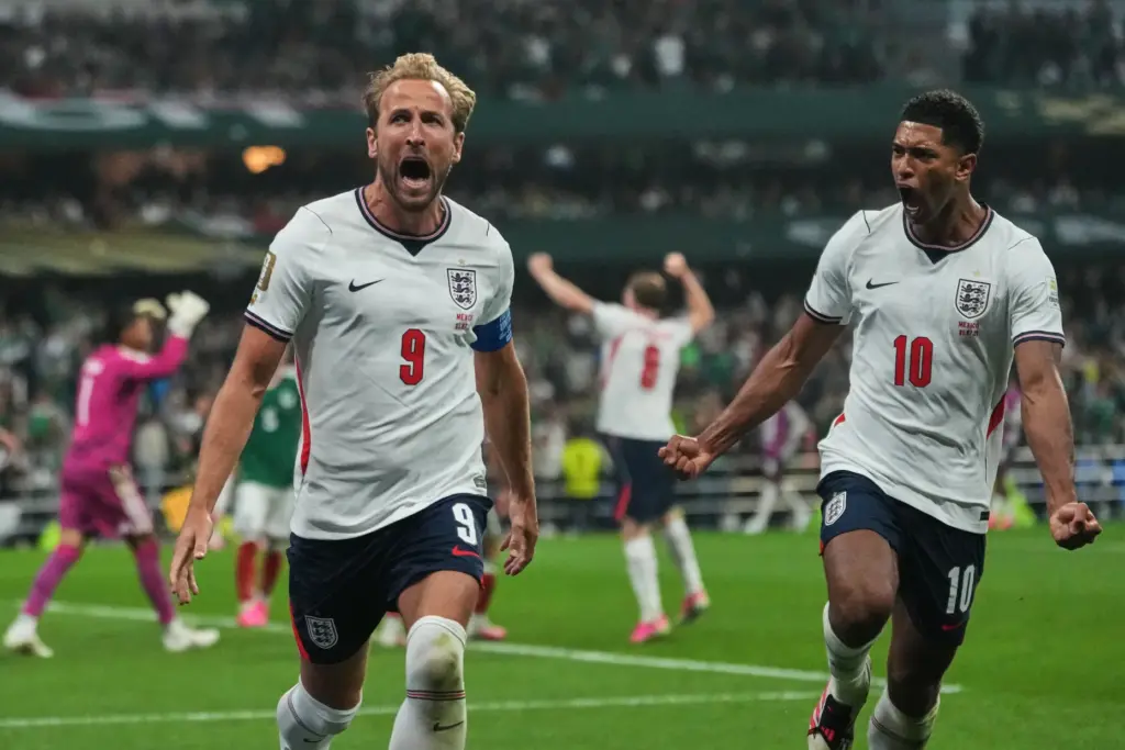 England’s Harry Kane (9) celebrates with Jude Bellingham (10) after...