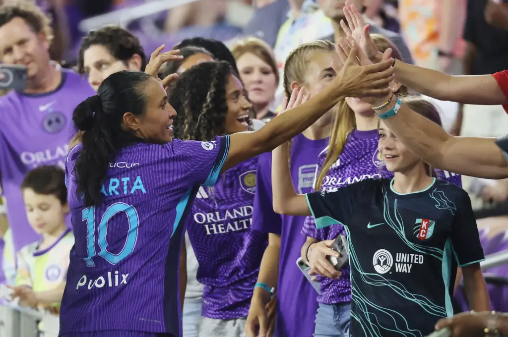 Orlando player Marta celebrates with fans after winning the Kansas...