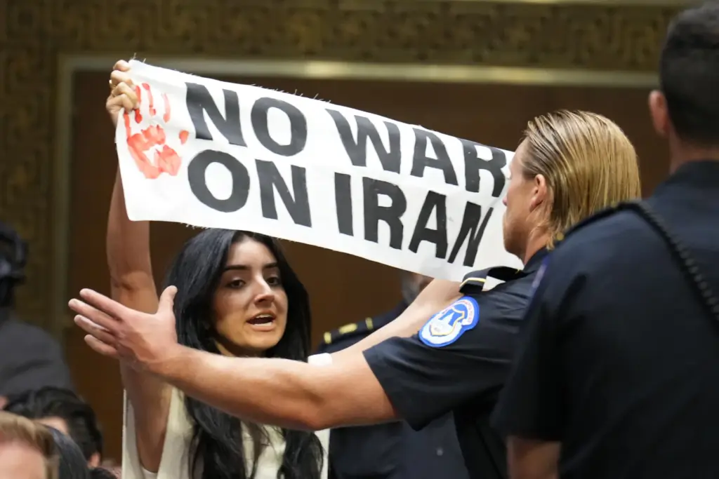 U.S. Capitol Police remove a protester as Defense Secretary Pete Hegseth testifies.