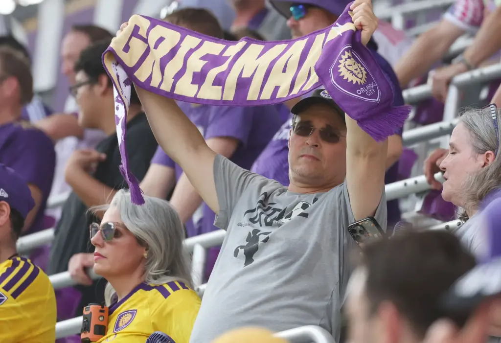 An Orlando City fan holds a Griezmann scarf during the...