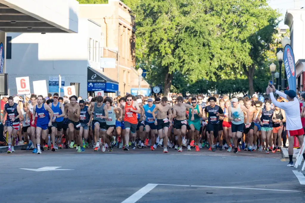 Runners take off for the start during the Watermelon 5K...