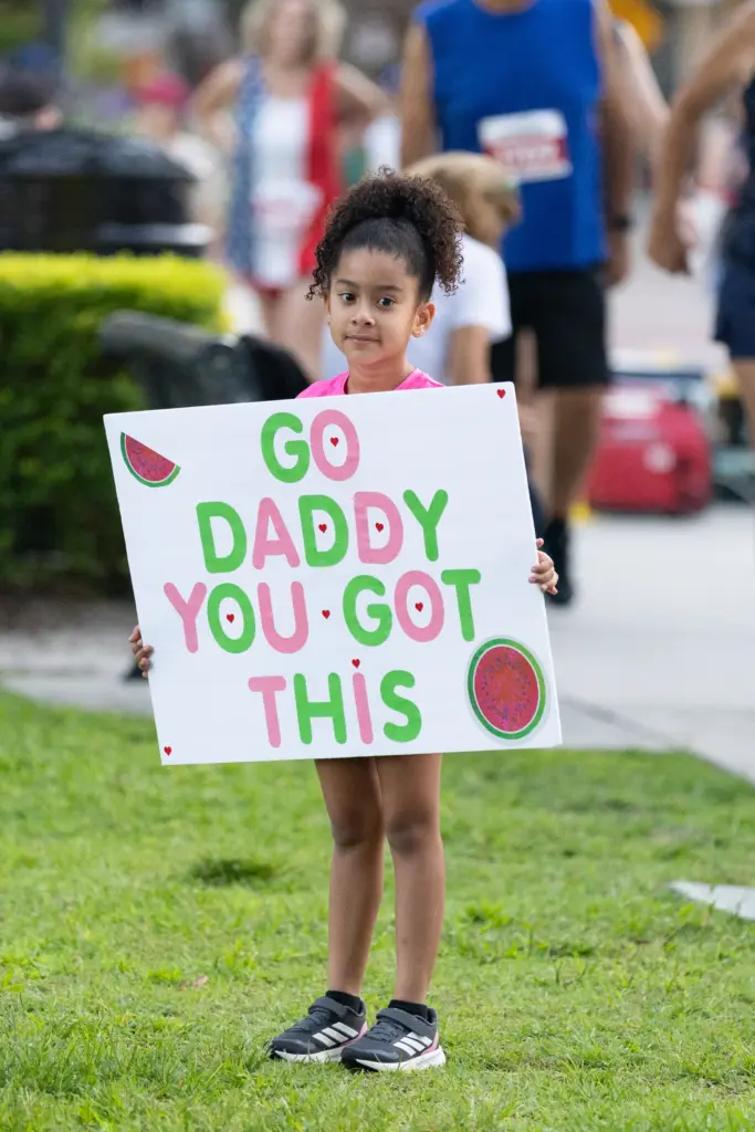 Girl gets ready to cheer on her dad during the...