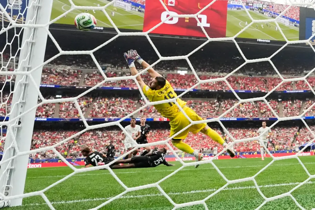 Morocco's Azzedine Ounahi scores on Canadian goalkeeper Maxime Crepeau.