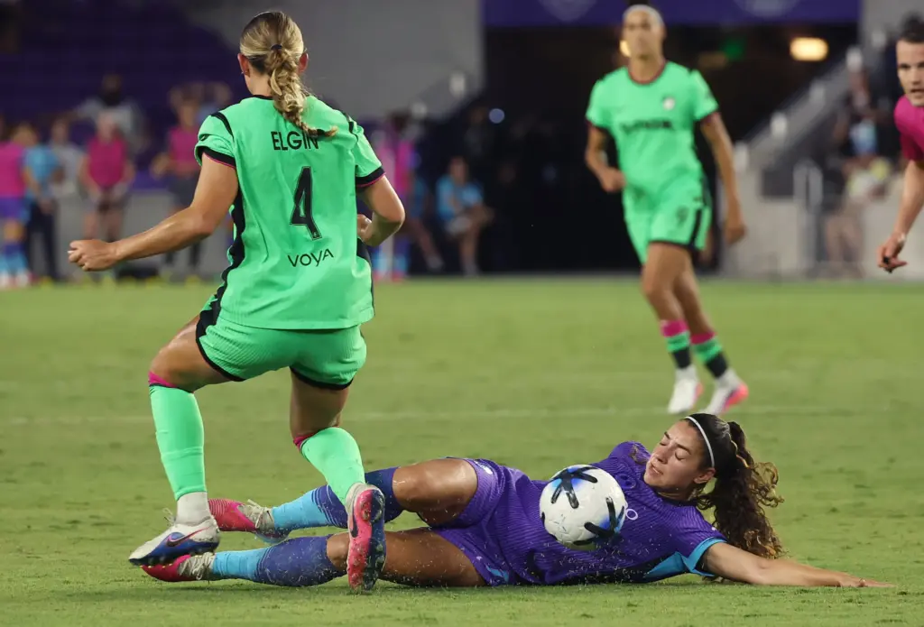 Orlando player Angelina (bottom) dives beneath Boston player Emerson Elgin...