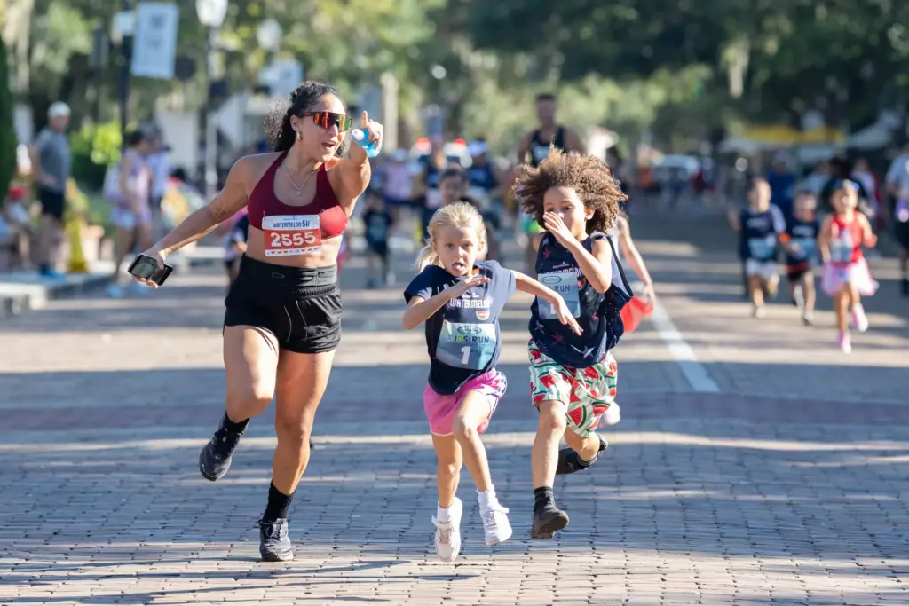Runners compete in a close race during the Kids Run...