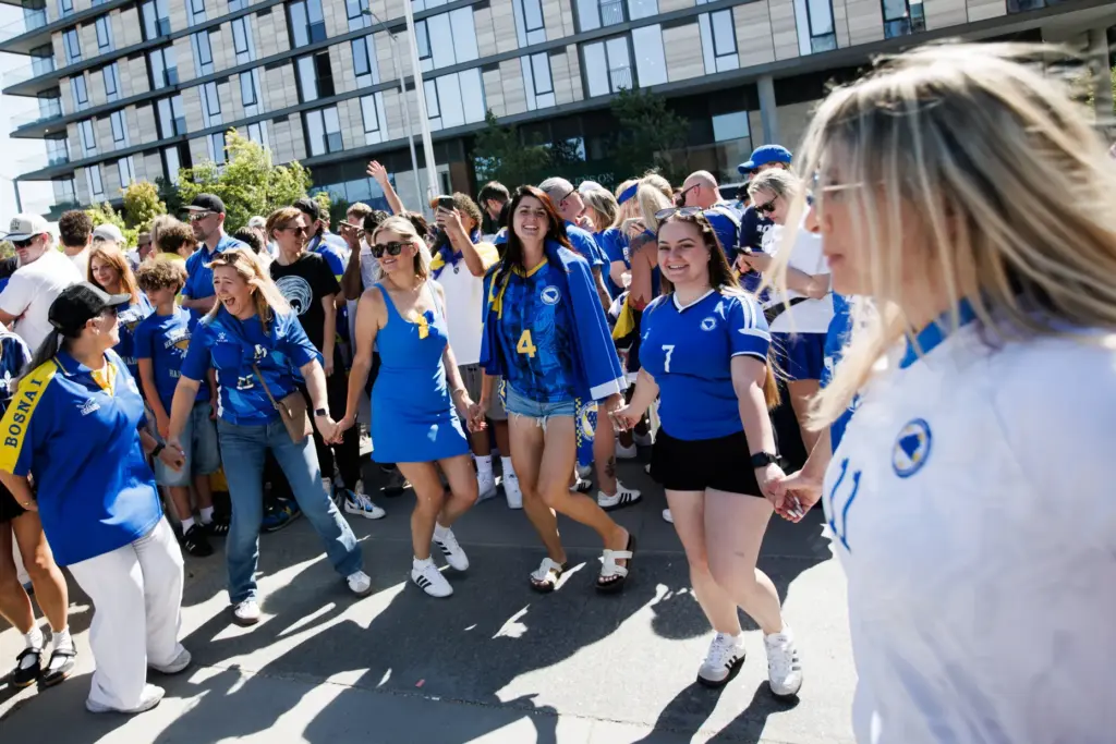 Supporters for Bosnia and Herzegovina perform a traditional Bosnia and...
