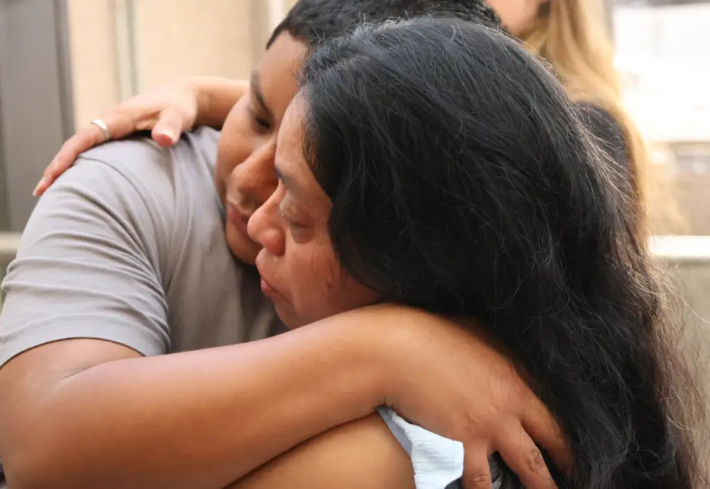 Olga Perez, right, longtime translator for the Guatemala Maya Center in Lake Worth Beach, hugs her son Romeo, 16, as she prepares to board a flight to Guatemala City on Monday at Fort Lauderdale-Hollywood International Airport. A refugee from violence in her country decades ago, she self-deported after being detained by ICE. (Joe Cavaretta/South Florida Sun Sentinel)