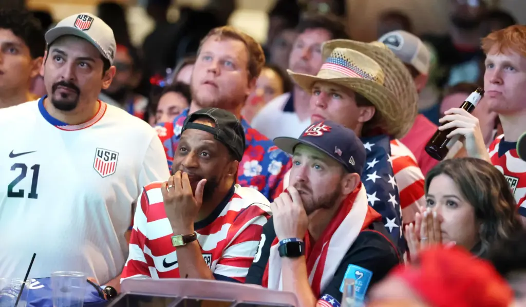 USA soccer fans watch in dejection after a Belgium goal...