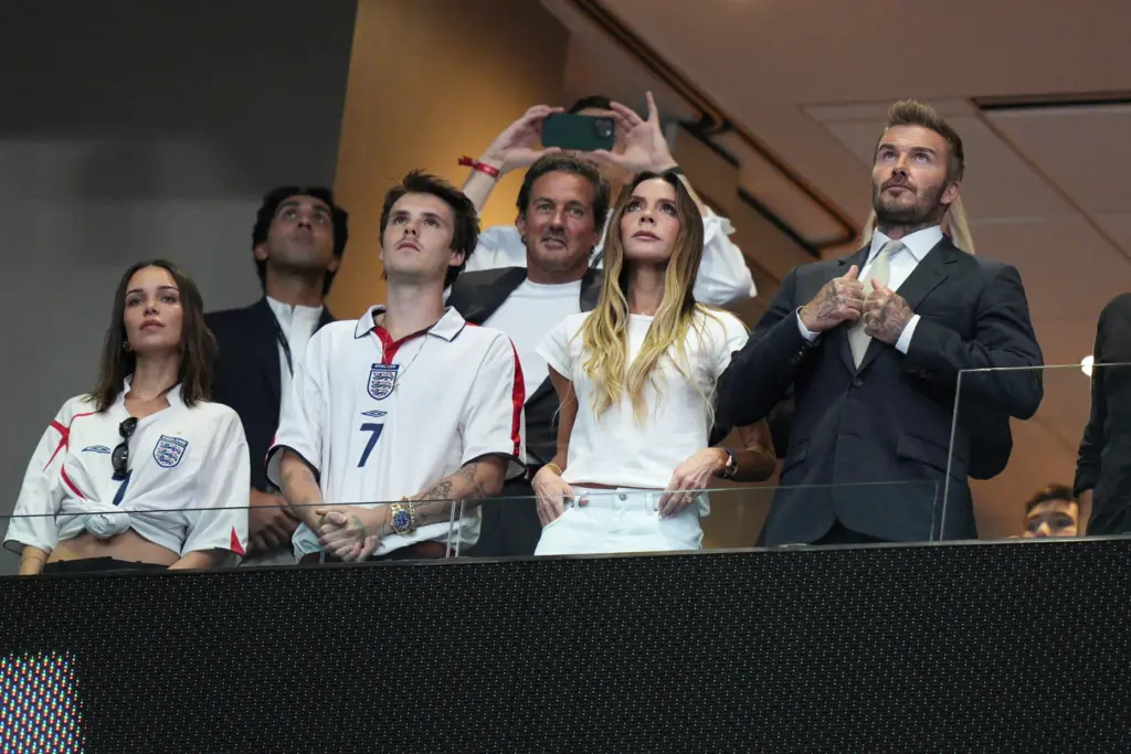 Former England soccer player David Beckham, right, stands before the...