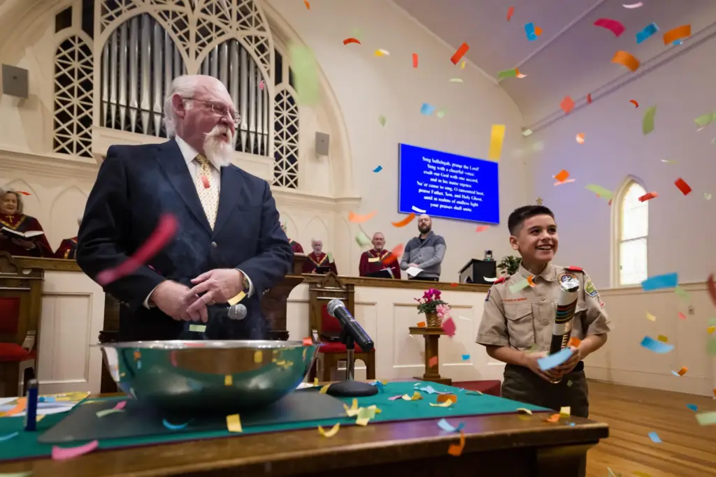 Kids from a local Scouting group helped the Rev. John Jackman celebrate at Trinity Moravian Church.