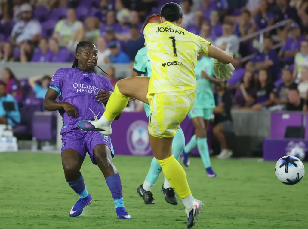 Orlando player Barbra Banda (left) scores a goal past KC...