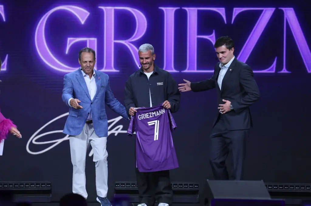 Antoine Griezmann, middle, is introduced as the newest player on...