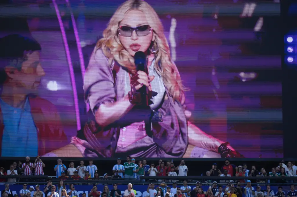 Spectators watch as Madonna performs during half time of the...
