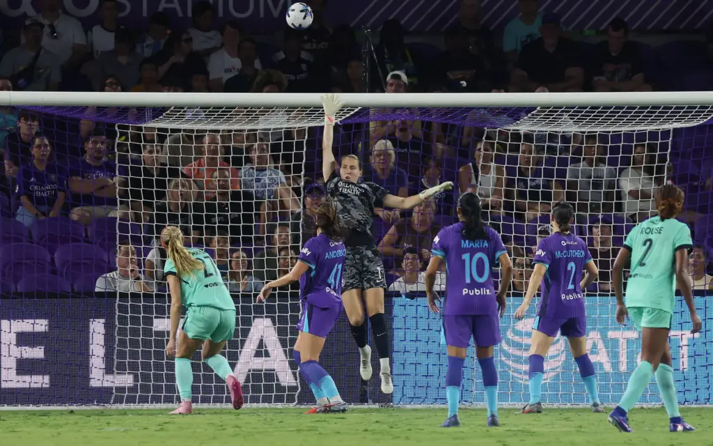 Orlando goalkeeper Anna Moorhouse (middle) knocks the ball over the...
