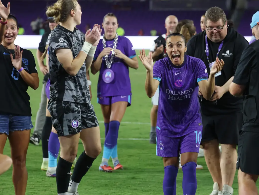 Orlando player Marta (10) celebrates with teammates after winning the...