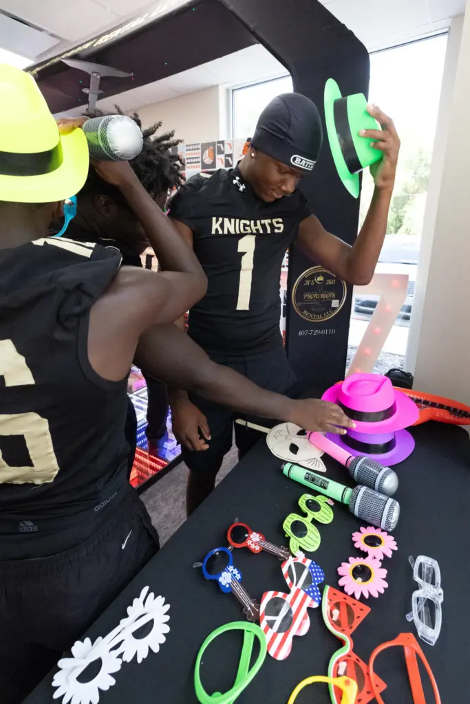 Players from Ocoee High School select props to use for...