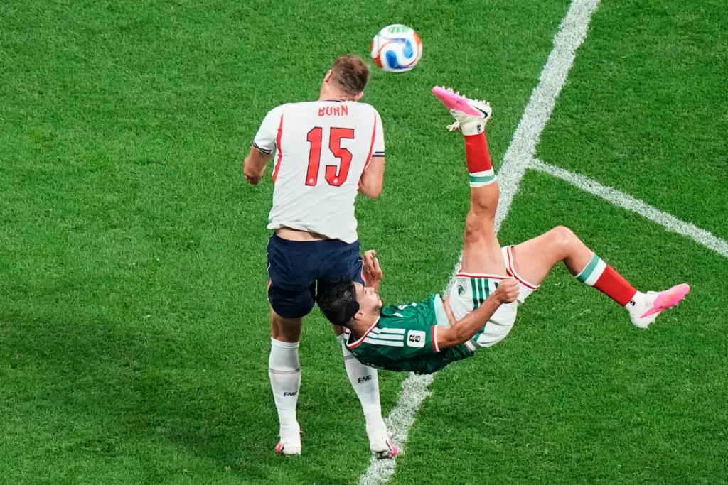 England’s Dan Burn (15) blocks an overhead kick by Mexico’s...