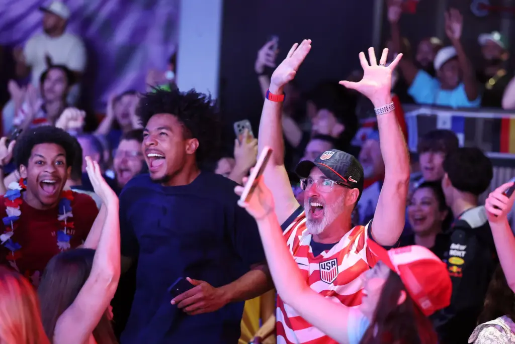 USA soccer fans cheer after a USA goal during a...