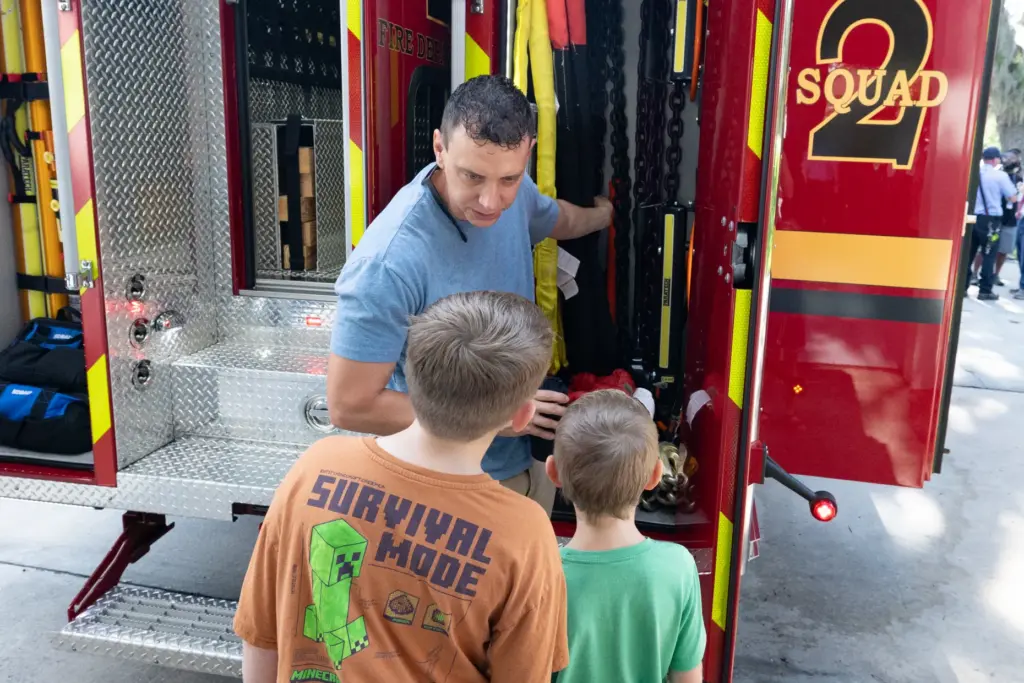 Firefighter Wesley Escue shows his kids Ryker, left, and Wyatt...