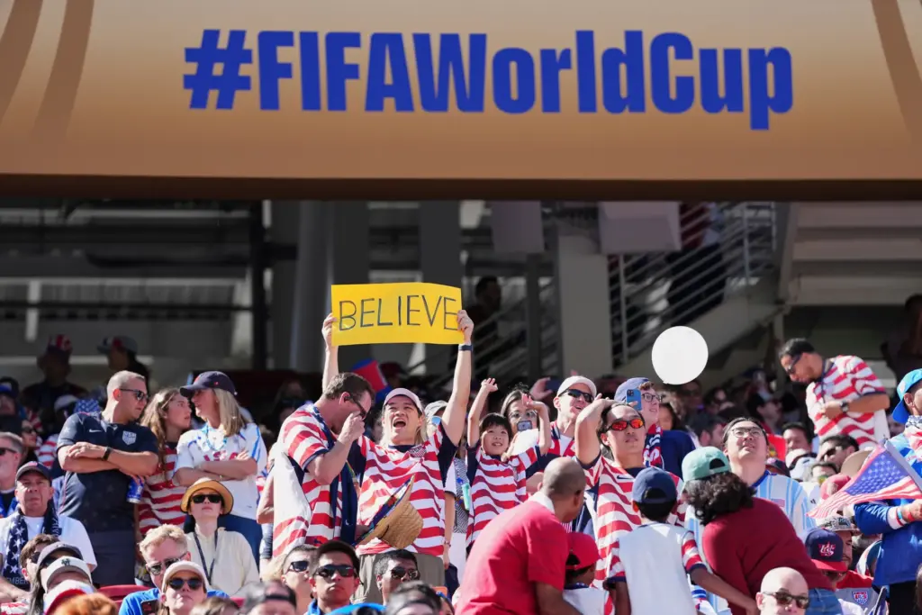 A fan holds a “Believe” sign prior to the World...