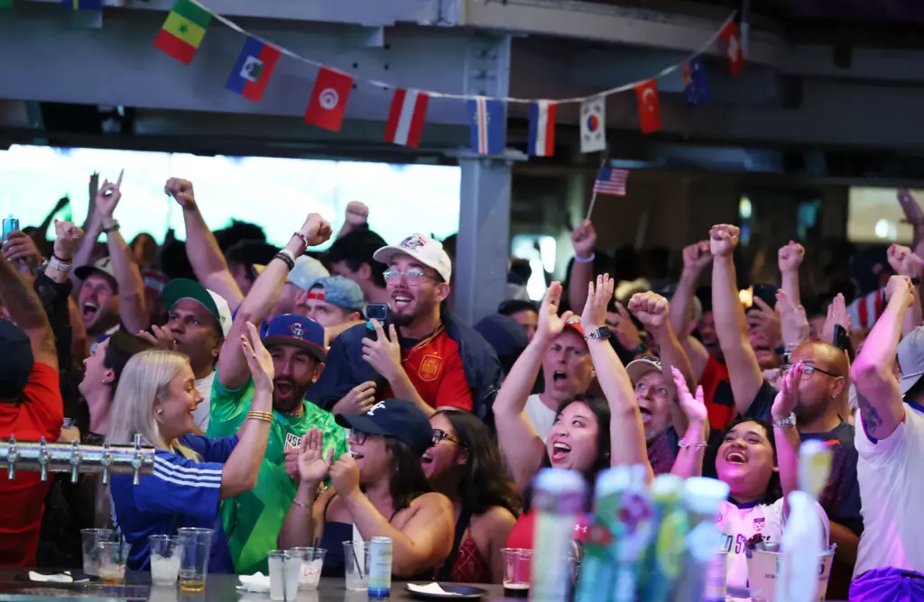 USA soccer fans cheer after a USA goal during a...