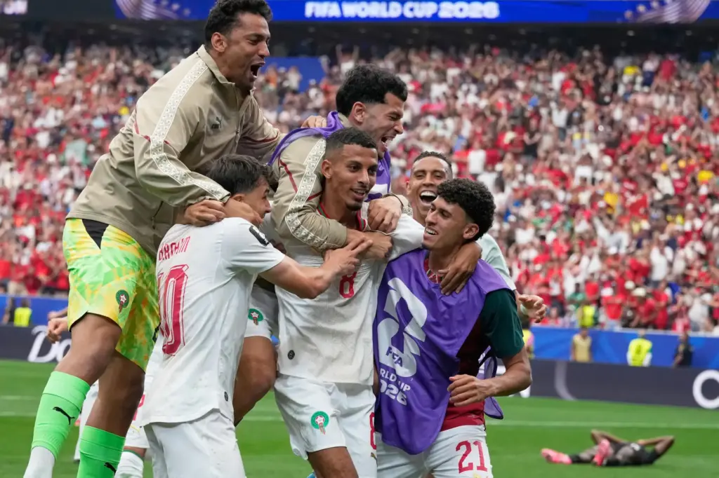 Morocco's Azzedine Ounahi is congratulated by teammates after scoring.