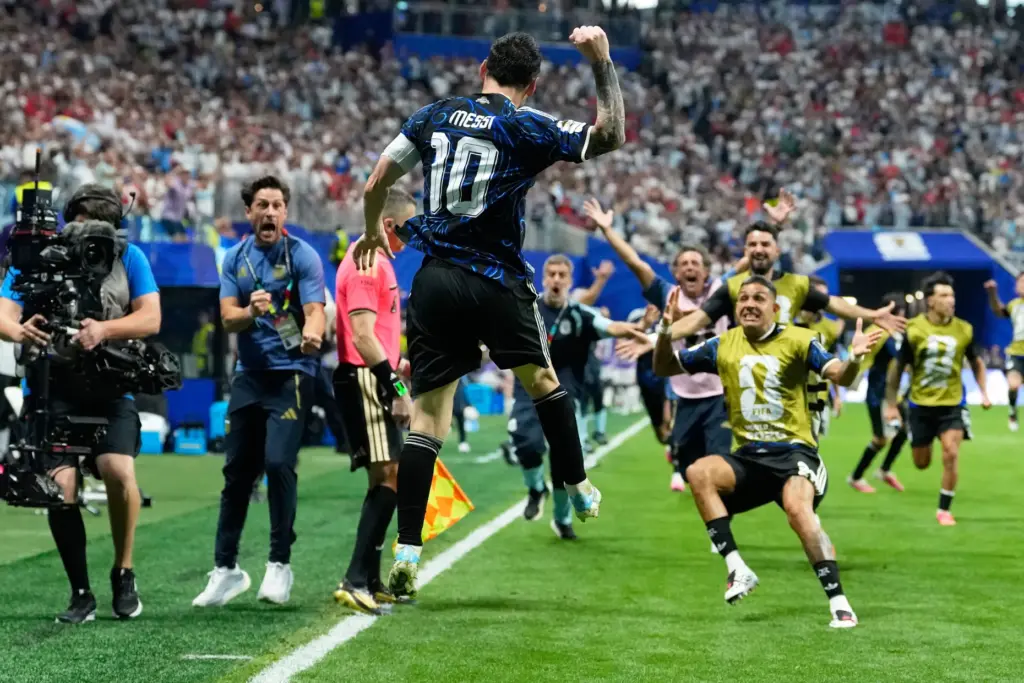 Argentina’s Lionel Messi celebrates after teammate Lautaro Martinez scored their...