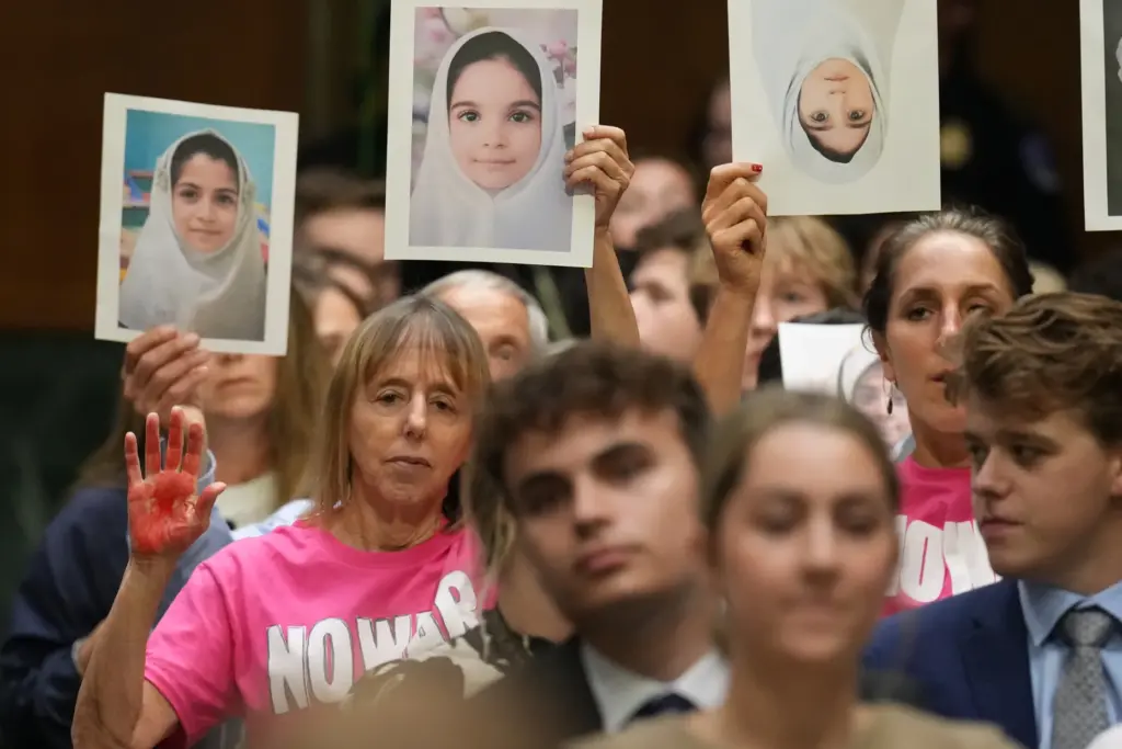 Code Pink co-founder Medea Benjamin, left, listens as Defense Secretary...