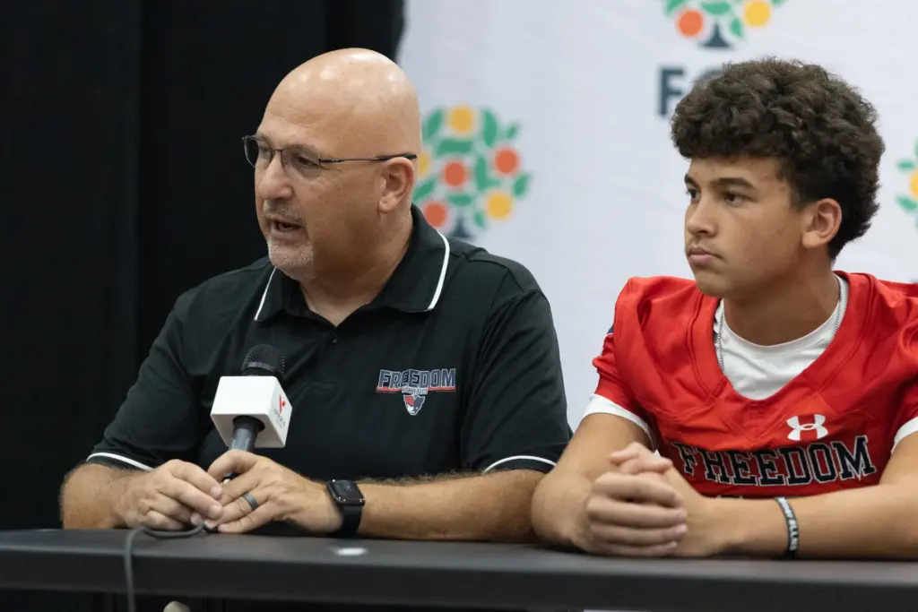 Freedom High School coach Brandon Pennington answers questions in an...
