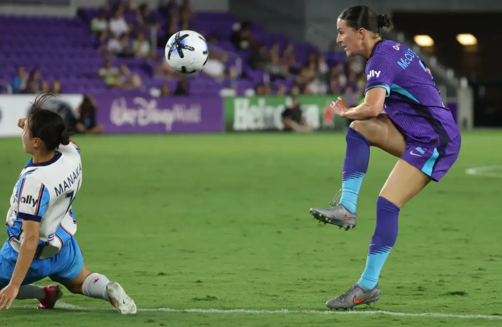 Orlando player Haley McCutcheon (right) tries to kick the ball...