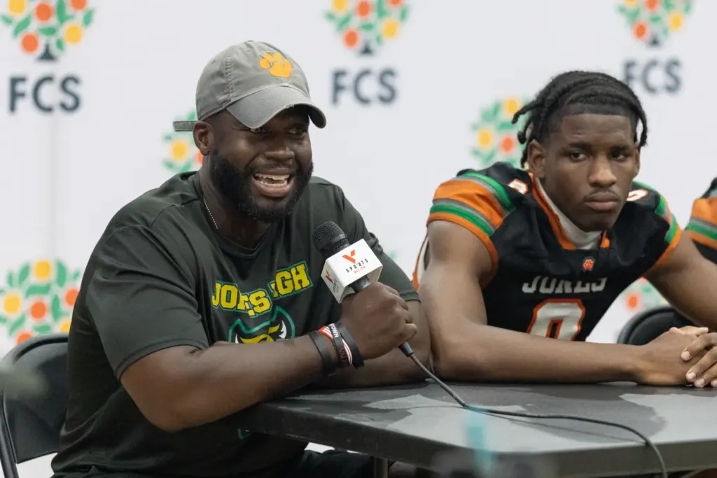 Jones High School coach Dale Williams answers questions in an...