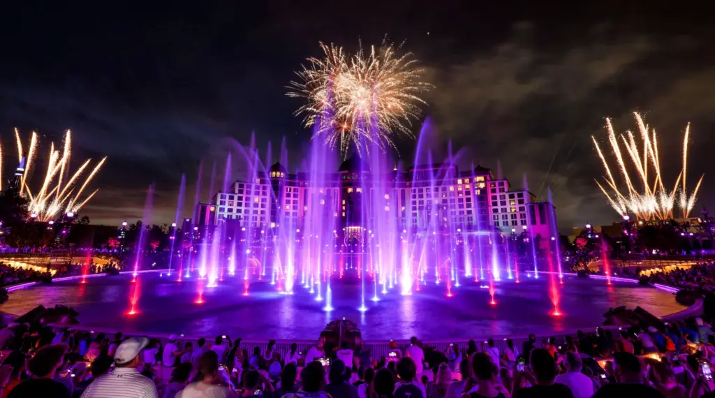 Guests watch the debut of the first nighttime finale fireworks...