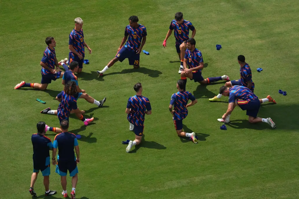 Spanish players warm up before the World Cup final soccer...