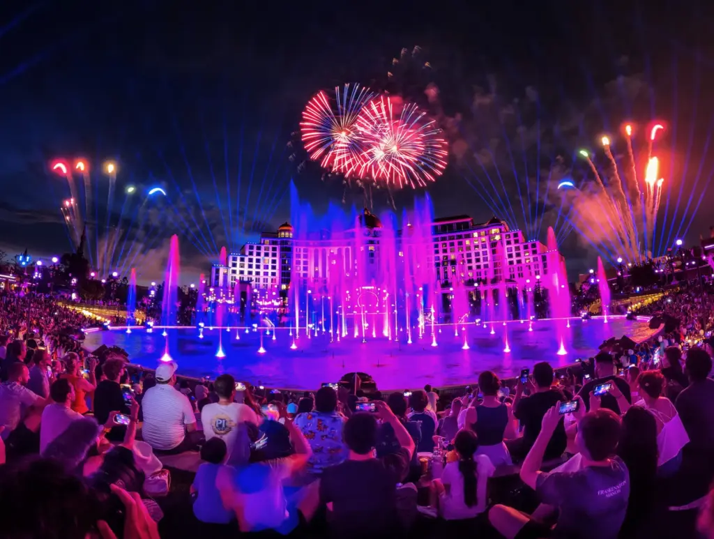 Guests watch the debut of the first nighttime finale fireworks...