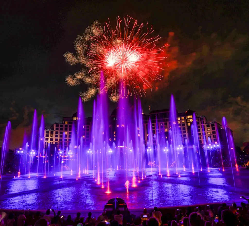 Guests watch the debut of the first nighttime finale fireworks...