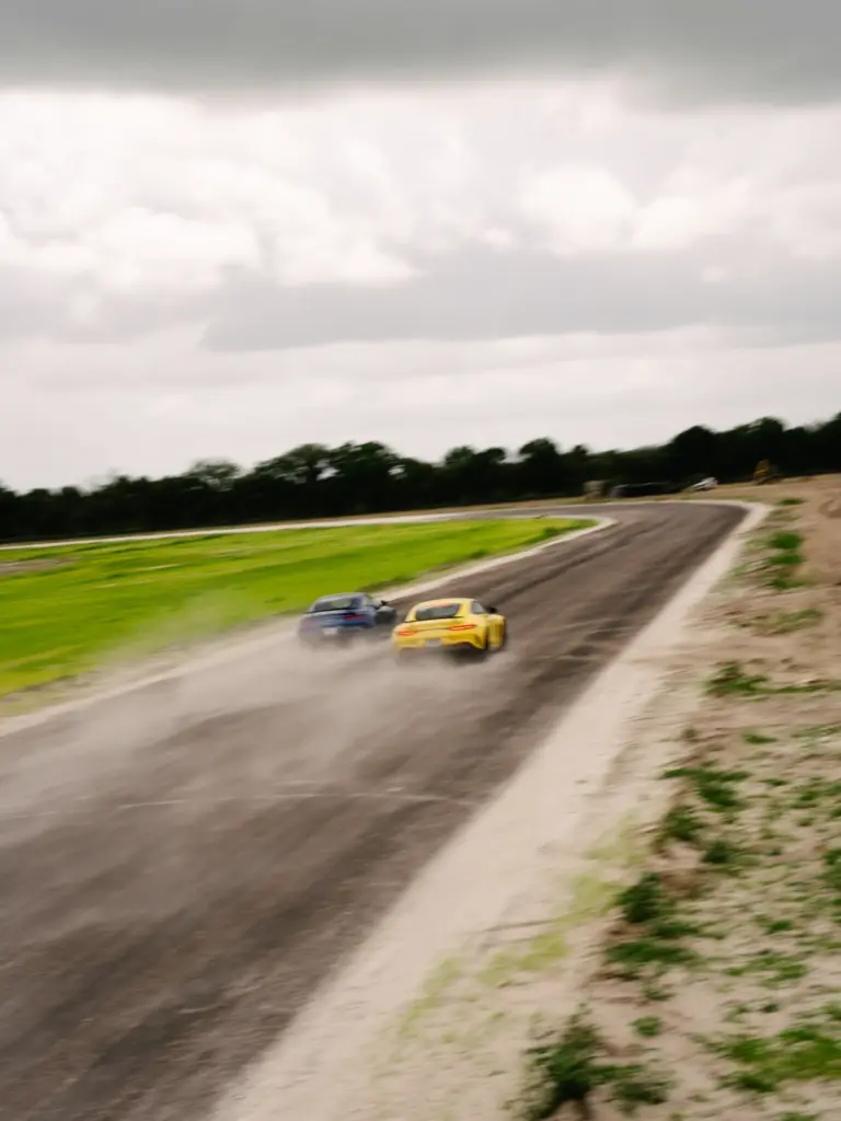 Two cars speed down the track at the P1 Motor...