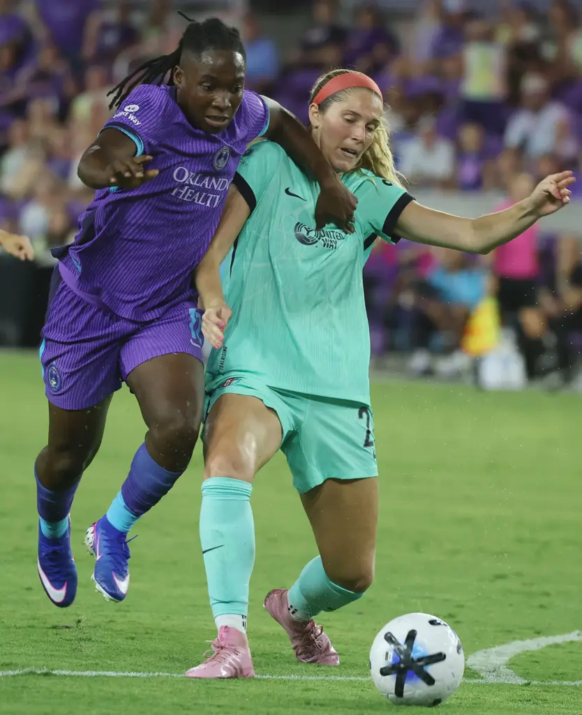 Orlando player Barbra Banda (left) shoves away KC player Kayla...