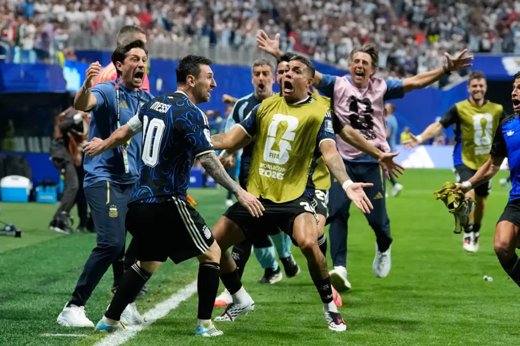 Argentina’s Lionel Messi celebrates after teammate Lautaro Martinez scored their...