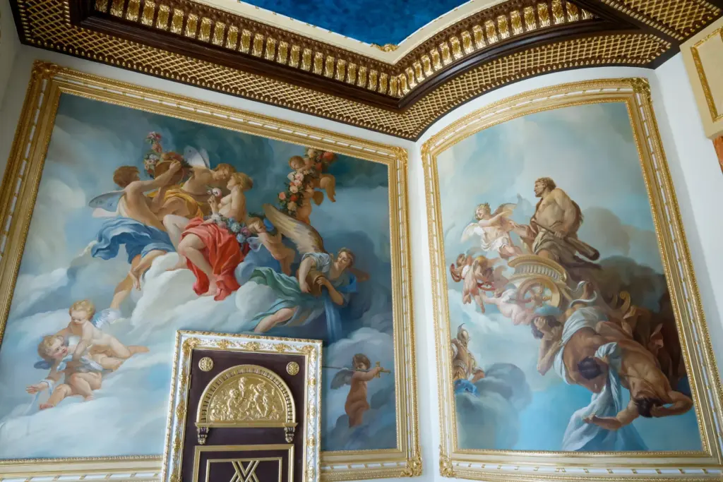 Hand-painted ceiling and wall murals decorate an ornate salon adjoining...