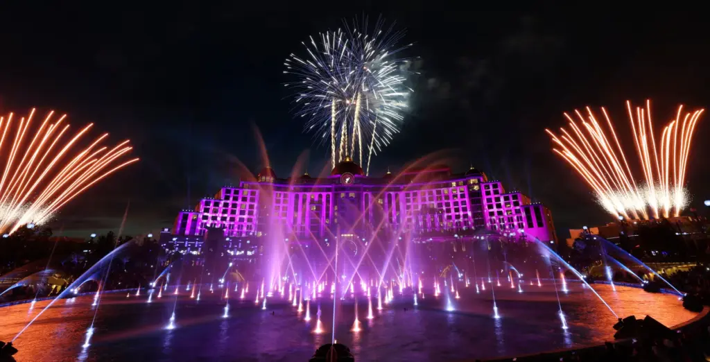Guests watch the debut of the first nighttime finale fireworks...